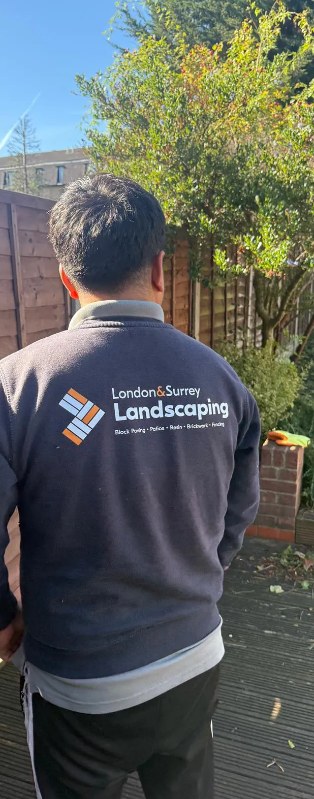 Our team member in branded London & Surrey Landscaping uniform on site